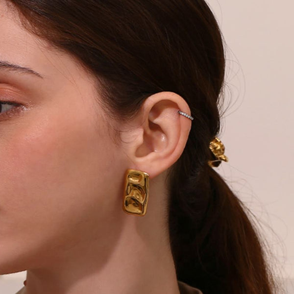 Woman wearing gold earrings 