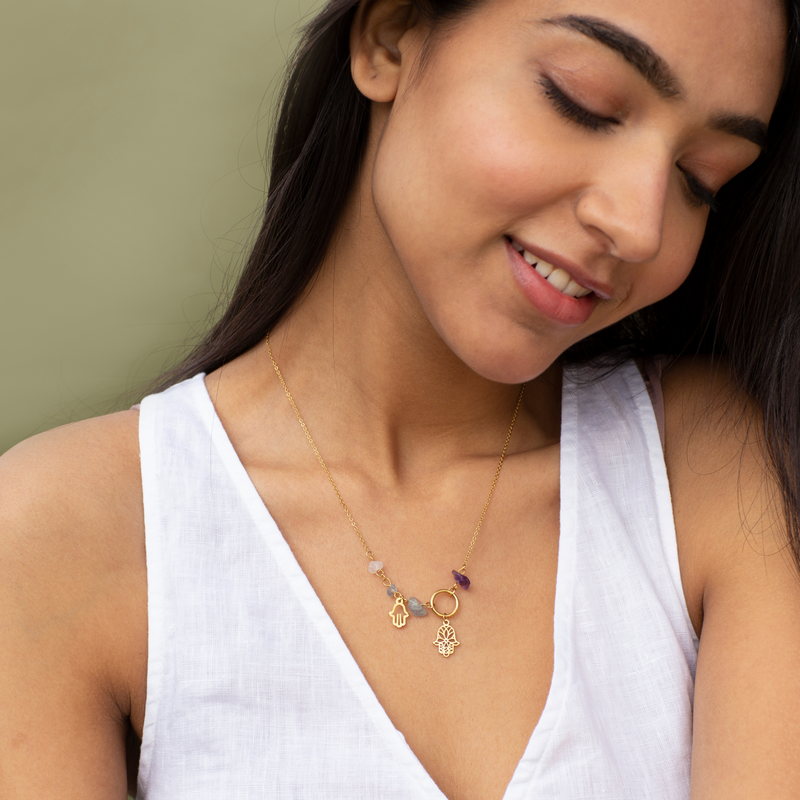 Hamsa Amulet Necklace by FASHKA, model pose.