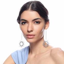 Silver Sun Dangler Earrings by FASHKA, worn by the model.